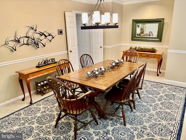 dining room featuring carpet, crown molding, baseboards, and a notable chandelier