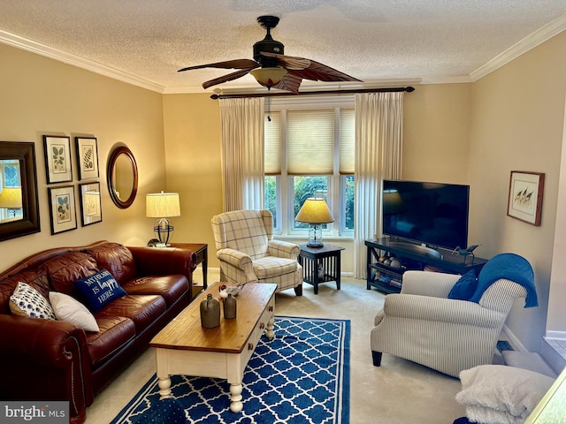 living room featuring baseboards, a ceiling fan, a textured ceiling, crown molding, and carpet floors