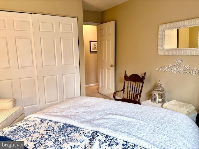 carpeted bedroom featuring a closet