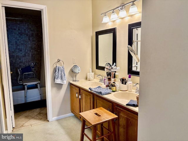 full bathroom featuring tile patterned floors, a sink, baseboards, and double vanity