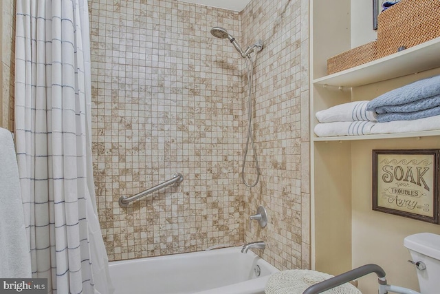 bathroom featuring shower / bath combination with curtain and toilet