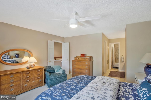 carpeted bedroom with connected bathroom, ceiling fan, and a textured ceiling