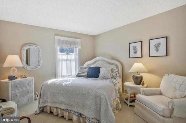 bedroom featuring carpet and a textured ceiling