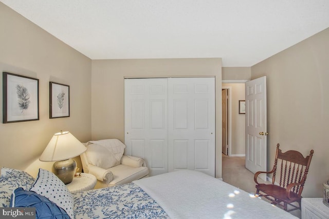 bedroom with a closet and light colored carpet