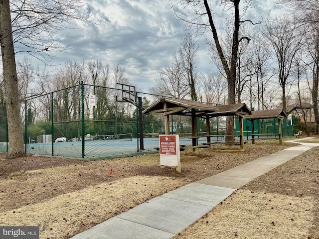 surrounding community with community basketball court and fence