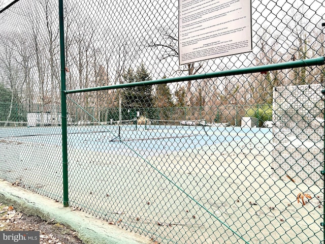 view of tennis court with fence