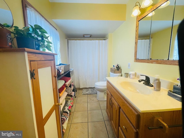 full bathroom with tile patterned flooring, vanity, and toilet