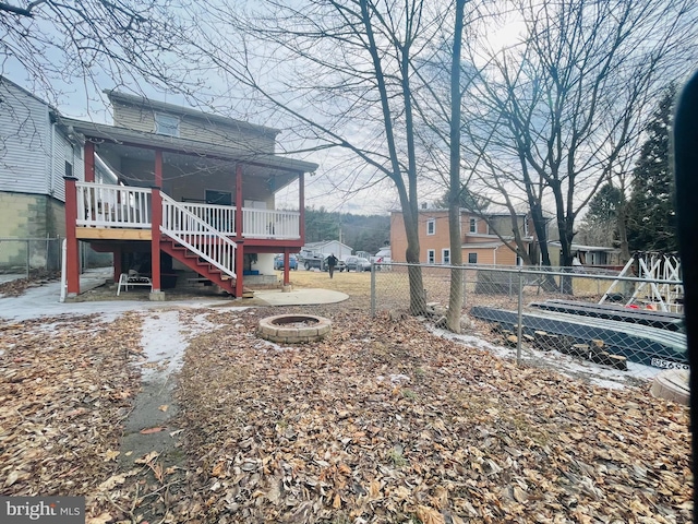 view of yard with an outdoor fire pit, stairs, and fence