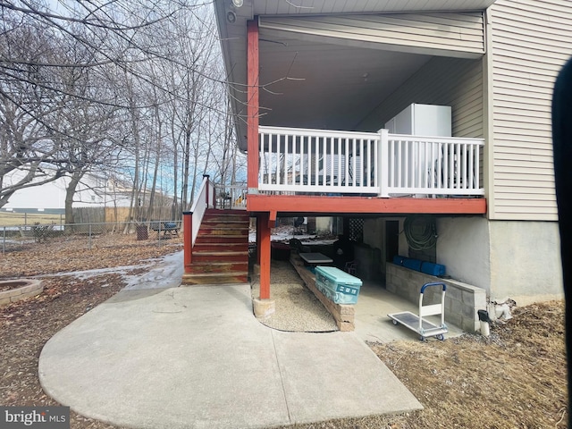 view of home's exterior featuring a patio, stairway, fence, and a wooden deck