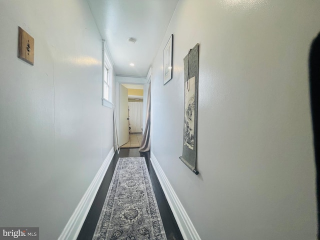 hall featuring baseboards