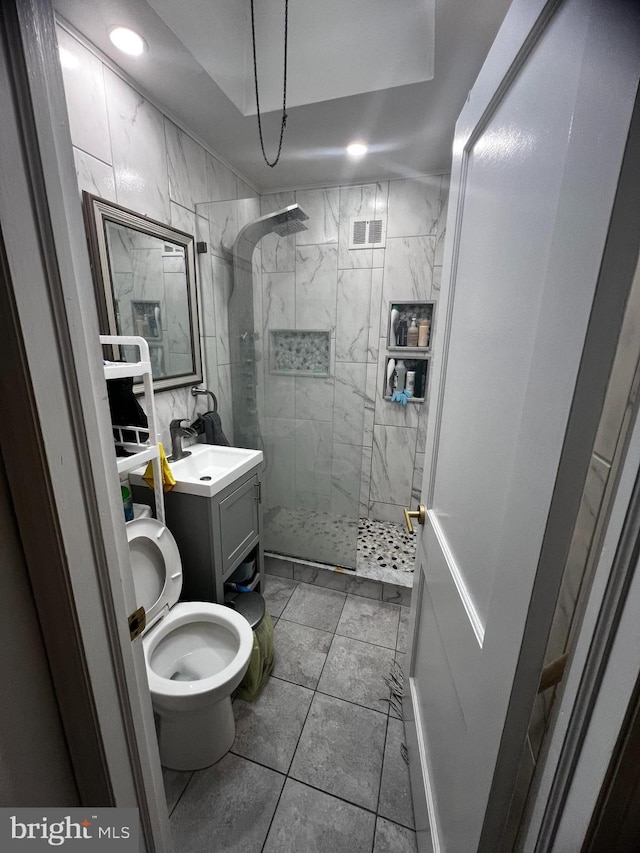 bathroom with recessed lighting, visible vents, toilet, vanity, and walk in shower