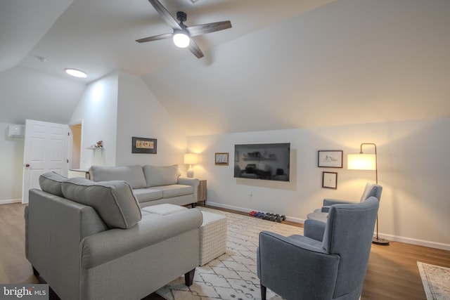 living room featuring lofted ceiling, ceiling fan, baseboards, and wood finished floors