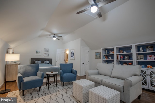 living area featuring ceiling fan, baseboards, vaulted ceiling, and wood finished floors