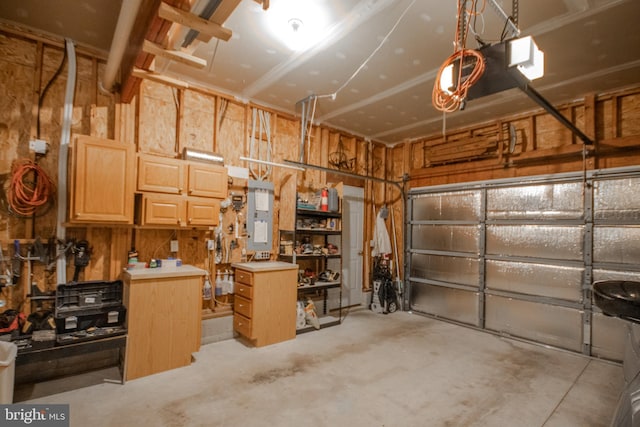 garage with electric panel and a garage door opener