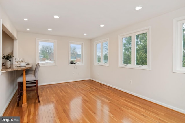 home office featuring recessed lighting, baseboards, and light wood finished floors