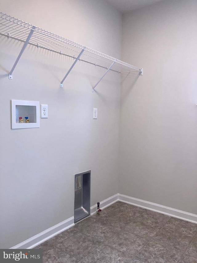 clothes washing area with laundry area, baseboards, and washer hookup