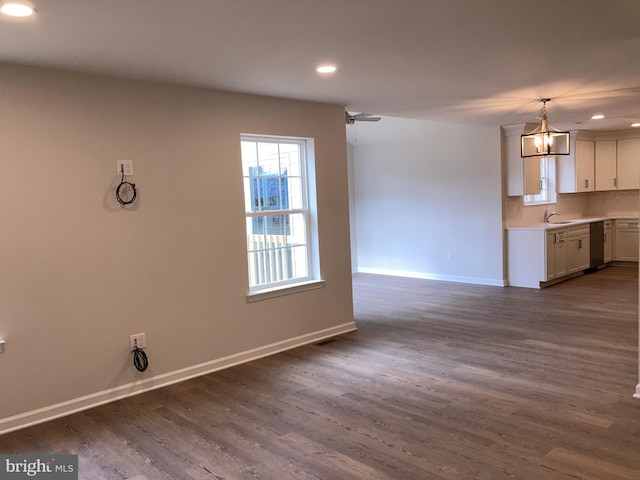 interior space with recessed lighting, dark wood-type flooring, a sink, a ceiling fan, and baseboards