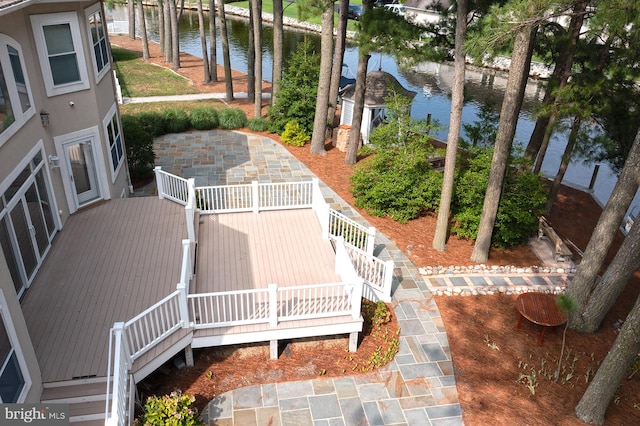 exterior space with a water view, stairs, and a patio