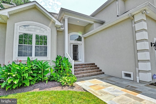 property entrance featuring stucco siding