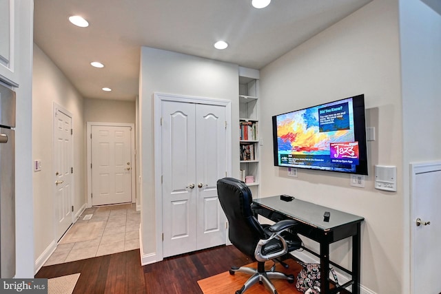 home office featuring built in shelves, baseboards, wood finished floors, and recessed lighting