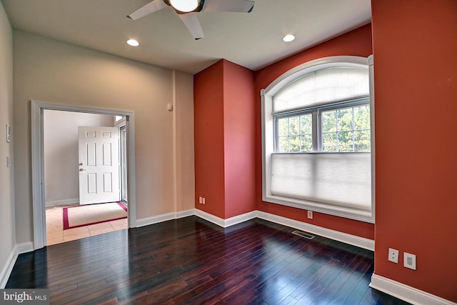 empty room with hardwood / wood-style flooring, baseboards, visible vents, and recessed lighting