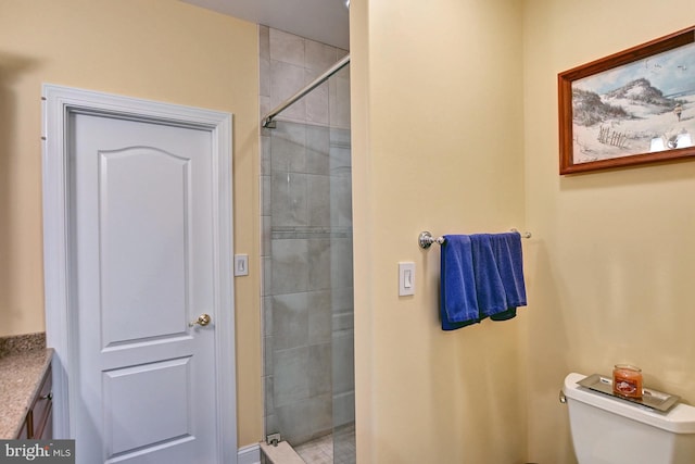 bathroom featuring a shower stall and toilet