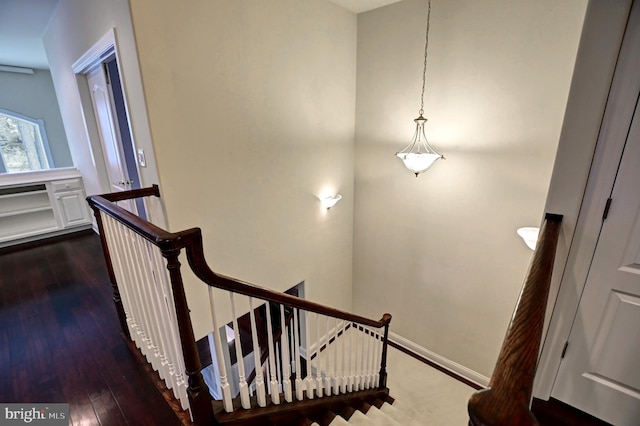 stairs with baseboards and wood finished floors