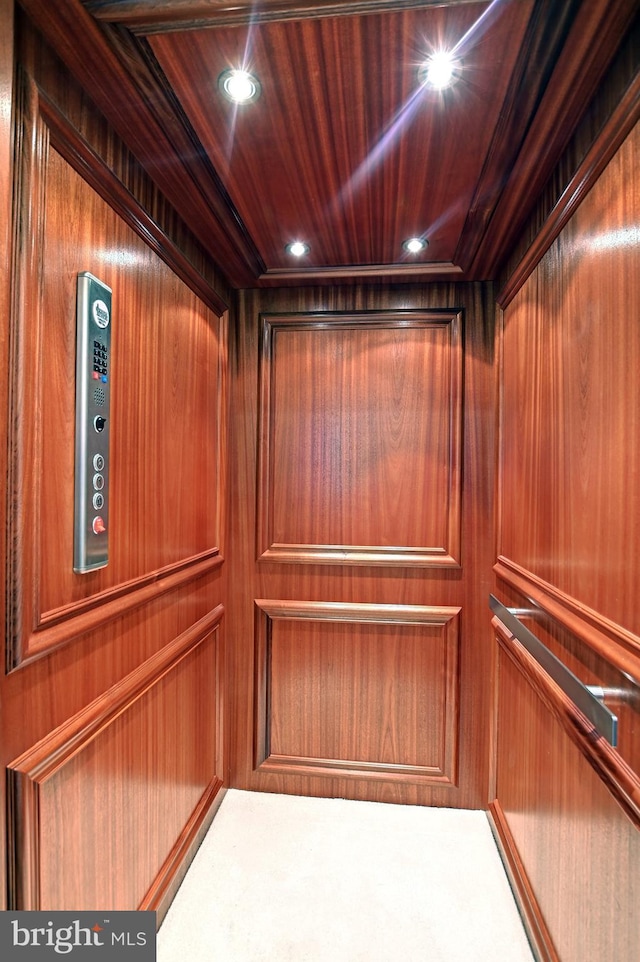 details featuring recessed lighting, wood ceiling, and elevator