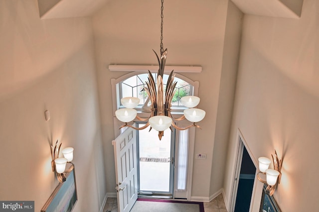 foyer entrance with a high ceiling, plenty of natural light, and baseboards