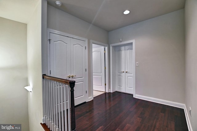 hallway featuring recessed lighting, wood finished floors, and baseboards