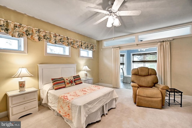 bedroom featuring light carpet, ceiling fan, and baseboards