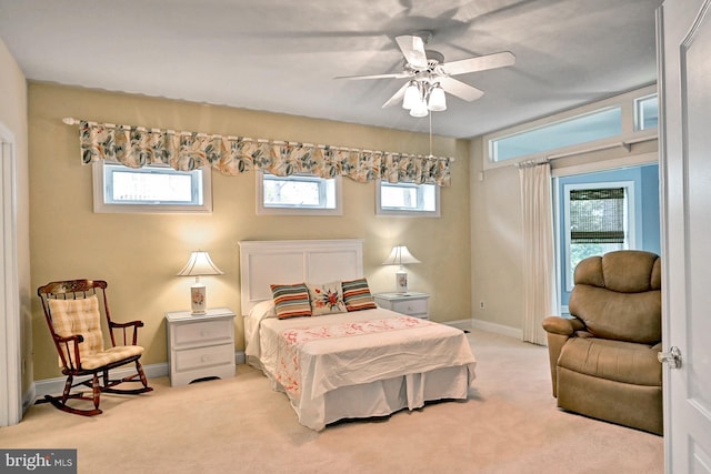 bedroom featuring light carpet and multiple windows