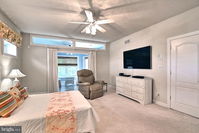 bedroom with a ceiling fan, visible vents, and light carpet