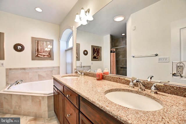 bathroom featuring a bath, a tile shower, a sink, and tile patterned floors