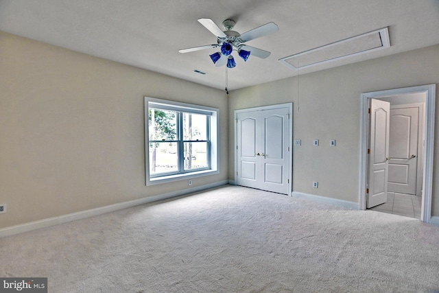 unfurnished bedroom with carpet floors, visible vents, baseboards, a closet, and attic access