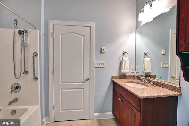 bathroom with  shower combination, tile patterned flooring, baseboards, and vanity