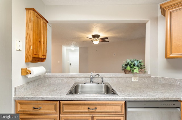 kitchen featuring light countertops, brown cabinetry, a ceiling fan, a sink, and dishwasher