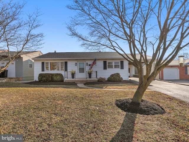 ranch-style house with a garage and a front yard