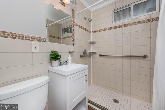 bathroom with ornamental molding, a tile shower, and toilet