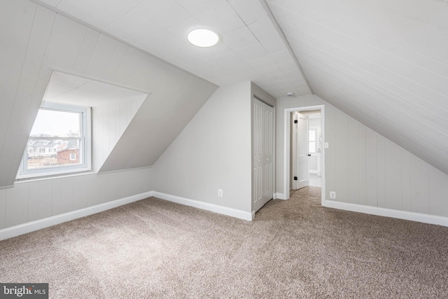 bonus room featuring carpet floors, baseboards, and lofted ceiling