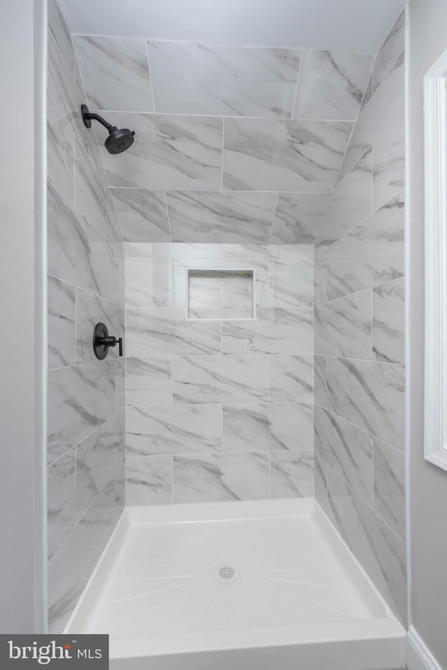 bathroom with tiled shower