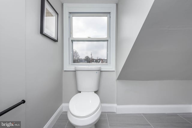 bathroom with toilet and baseboards