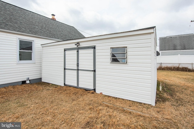 view of shed featuring fence