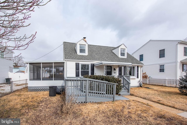 new england style home with a chimney, a shingled roof, a porch, a sunroom, and fence