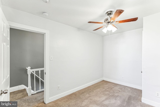 spare room featuring carpet floors, baseboards, and a ceiling fan