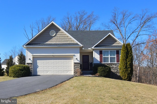 craftsman inspired home with driveway, stone siding, an attached garage, and a front yard