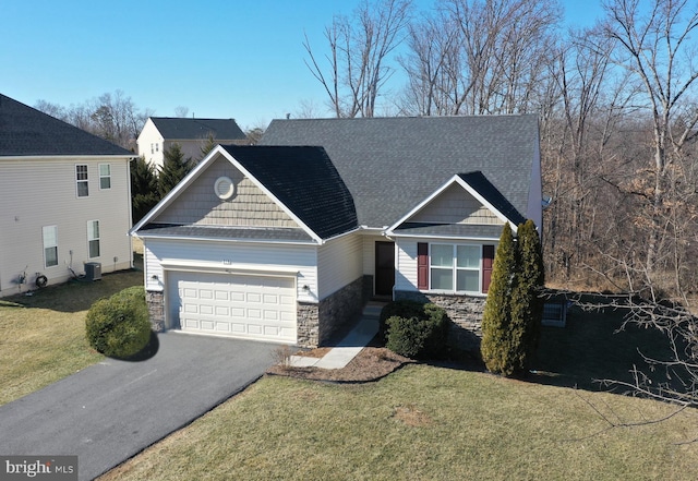 craftsman house featuring a garage, stone siding, aphalt driveway, and a front yard