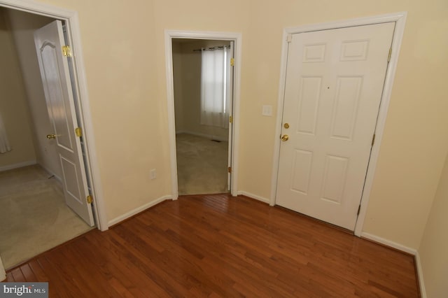 interior space featuring baseboards and wood finished floors