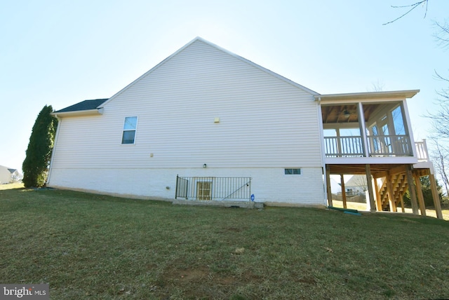 view of side of property with a sunroom, stairway, and a yard