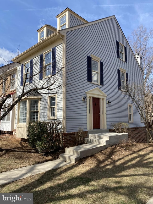 view of front facade with a chimney